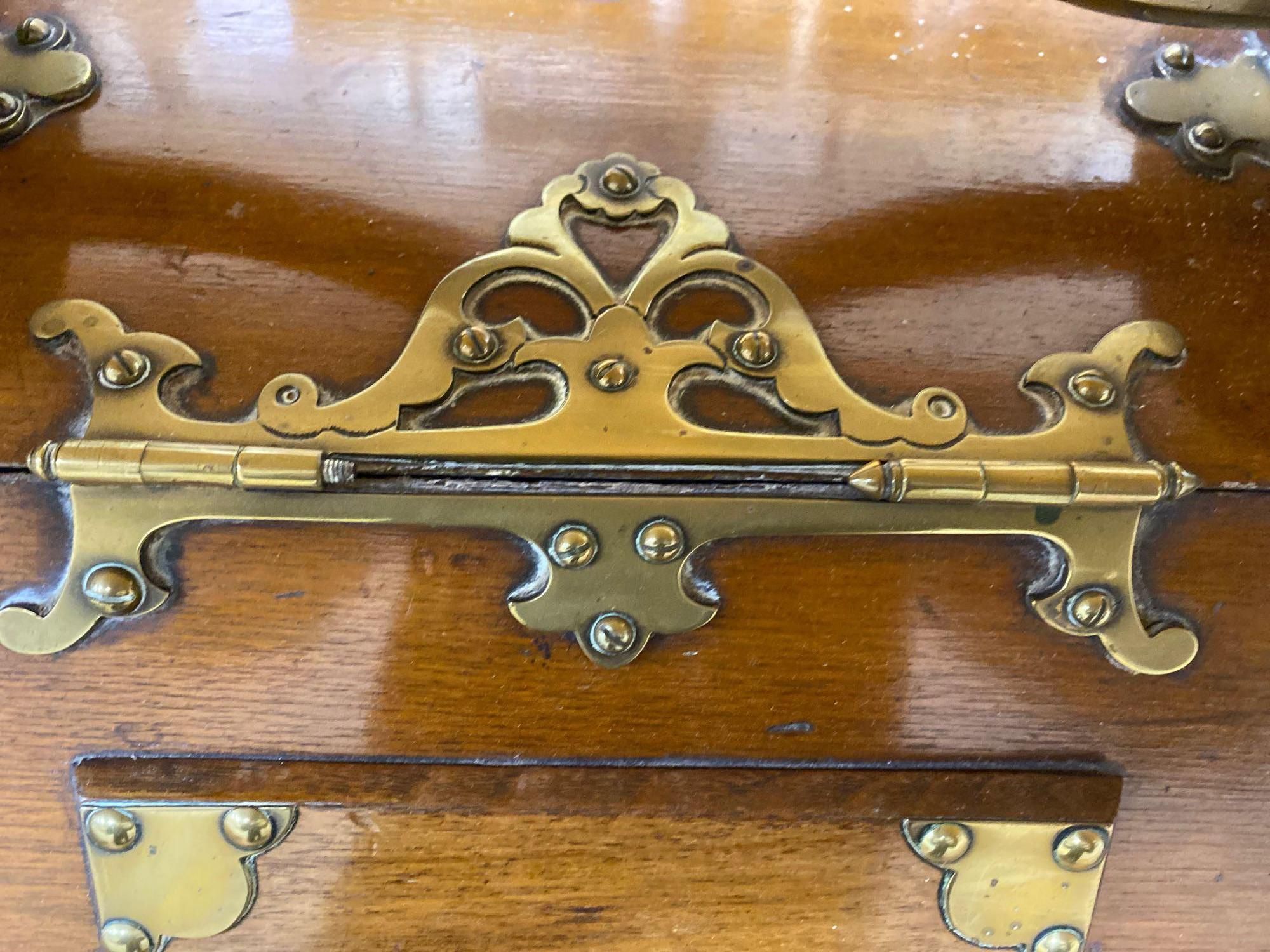 A Gothic revival walnut and brass mounted coal box on ceramic casters, 35cm wide